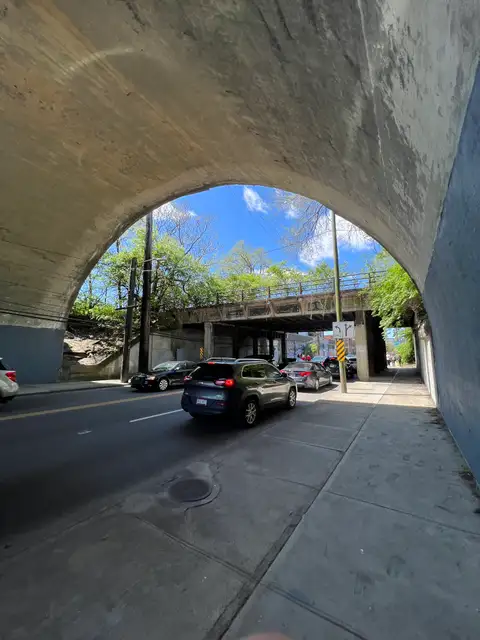 Concrete arch frames the rhythm of city life.